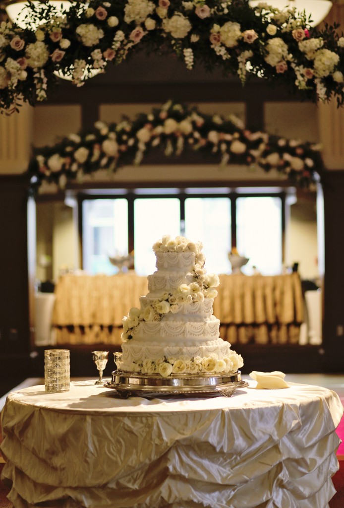 fresh flower arbor | floral arbor above wedding cake | msu riley center meridian ms | elegant wedding cake with fresh flowers | wedding flowers meridian 