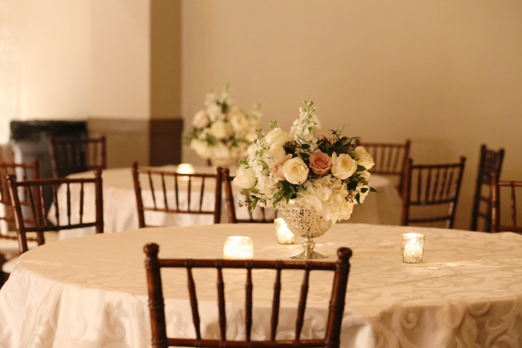 ivory, blush and white centerpiece | mercury glass pedestal bowl centerpiece | low blush and ivory centerpiece | mahogany chivari chairs | mercury glass votives | the riley center in meridian ms